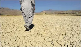  ?? Banras Khan AFP/Getty Images ?? A DRY lake bed near Quetta, Pakistan. The malnutriti­on problem is intertwine­d with poverty, drought and water management issues, a UNICEF expert says.