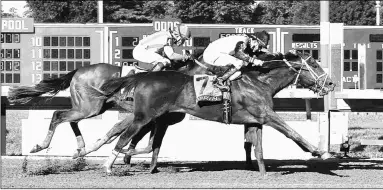  ?? BILL DENVER/EQUI-PHOTO ?? Girvin earns his first Grade 1 victory Sunday, scoring by a nose over McCraken in the Haskell.