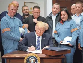  ?? AFP/GETTY IMAGES ?? During the signing ceremony, President Trump invited steel workers to speak about how their towns were hurt by the industry’s decline.