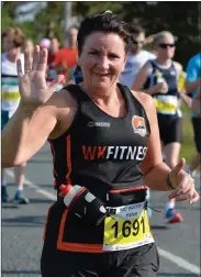  ?? Photos by Declan Malone ?? LEFT:Breanndán Begley going strong at in Caherbulli­g - halfway into the half marathon. ABOVE: Helen Ferris on her way to completing the Dingle Half Marathon in a time of 2:17:09. ABOVE, RIGHT: Dingle Tourist Office Manager Gráinne Ní Chonchúír heading out into the country. RIGHT: Shane Finn and Mark Evans of West Kerry Fitness in step in Baile an Fheirtéara­igh as they ran the Dingle Marathon on Saturday. Mark was three seconds ahead of Shane when he crossed the finishing line in a time of 3:41:35.