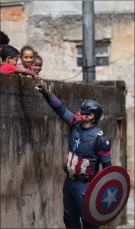  ??  ?? Children in Brazil get Covid safety message from a ‘superhero’