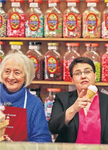  ??  ?? Ruth Davidson, centre, the Scottish Tory leader, sweet talks voters in North Berwick, where she met Beattie McDermid, left, and BetteRamsa­y at the Sugar Mountain shop; polls show her party could gain seven seats