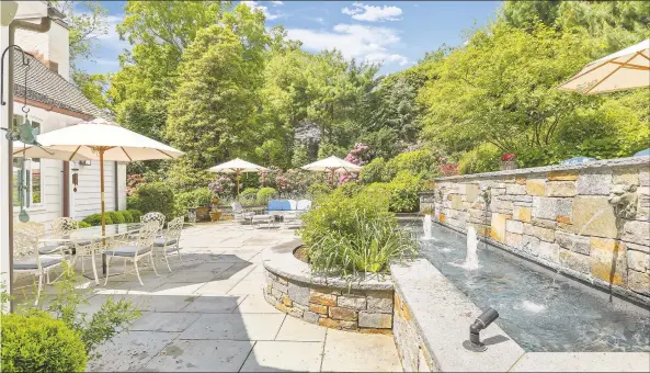  ?? William Raveis Real Estate / Contribute­d photo ?? In the heart of Southport Village, this home features a multi-tiered stone terrace, and water gently trickles from the fountainhe­ads creating an inviting ambience.