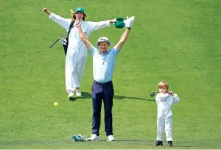  ?? GEORGE WALKER IV/THE ASSOCIATED PRESS ?? Peter Malnati and his wife, Alicia, celebrate Wednesday as their son, Hatcher, hits on the fifth hole during the par-3 contest at the Masters at Augusta National Golf Club in Augusta, Ga.