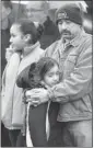  ?? The Associated Press ?? Mourners attend a memorial for shooting victims near Sandy Hook School on Sunday.