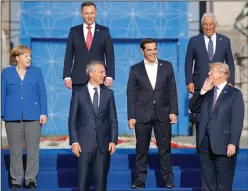  ?? Pablo Martinez Monsivais/AP ?? NATO: President Donald Trump, lower right, leans back to talk to from left, German Chancellor Angela Merkel, Polish President Andrzeji Duda, NATO Secretary General Jens Stoltenber­g, Greek Prime Minister Alexis Tsipras and Portuguese Prime Minister Antonio Costa during a group photo of NATO heads of state and government at Park Cinquanten­aire in Brussels, Belgium, on Wednesday. NATO leaders gathered in Brussels Wednesday for a two-day summit to discuss Russia, Iraq and their mission in Afghanista­n.