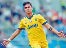  ??  ?? Juventus’ Paulo Dybala celebrates after scoring in their Italian league match against Sassuolo at the Mapei Stadium in Reggio Emilia. Juventus won 3-1. —