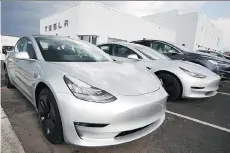  ?? DAVID ZALUBOWSKI/THE ASSOCIATED PRESS FILES ?? Model 3 sedans sit on display outside a Tesla showroom in Littleton, Colo., last month.