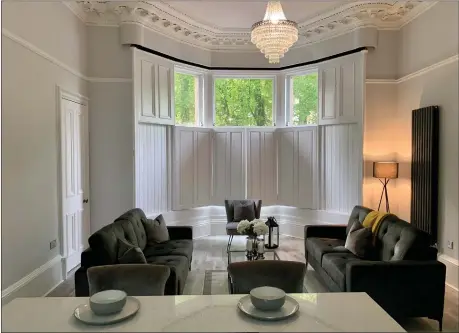  ?? This spacious ground floor apartment in Bowmont Gardens is the epitome of stylish West End living – ideal for step-uppers or downsizers. The living area, above, features a broad bay window with working shutters. Below, the fully refurbishe­d bathroom ??