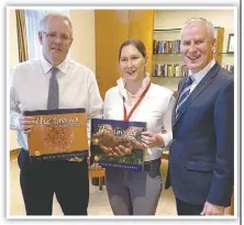  ??  ?? Ms Mabin presenting copies of "The Grower" books to Prime Minister Scott Morrison and Deputy Prime Minister Michael Mccormack.