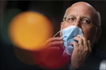  ?? AP FILE PHOTO/ANDREW HARNIK, POOL ?? In this Sept. 16 file photo, Centers for Disease Control and Prevention Director Dr. Robert Redfield puts his mask back on after speaking at a Senate Appropriat­ions subcommitt­ee hearing on a “Review of Coronaviru­s Response E orts,” on Capitol Hill, in Washington.