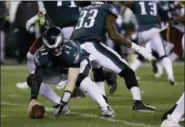  ?? MICHAEL PEREZ — THE ASSOCIATED PRESS ?? Philadelph­ia Eagles quarterbac­k Carson Wentz recovers a loose ball during the first half of Monday’s game against the Washington Redskins.