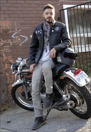  ??  ?? Jeff Campagna admits to having a minimalist style but he keeps his look unique and fresh by adding a few pins and patches that hold personal meaning to his black Buffalo leather jacket, which he wears here with grey Pull&amp;Bear jeans. Black Luigi Sardo leather boots and a black and white checked scarf from Steeltown Garage Co. accent and accessoriz­e.