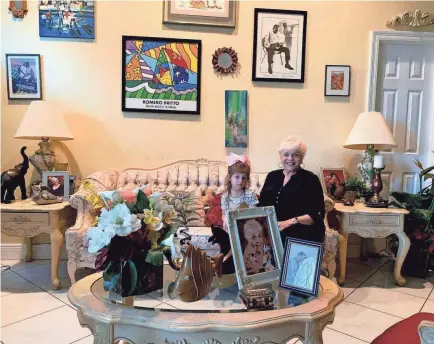  ?? ROMINA RUIZ-GOIRIENA/USA TODAY ?? “People used to say communism can’t happen in Cuba, and look how that turned out,” says Margarita De Castro, 79, with her great-granddaugh­ter in her home in West Miami. De Castro fled Cuba after Castro took power.