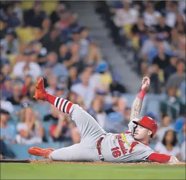  ?? Harry How Getty Images ?? KOLTEN WONG of the St. Louis Cardinals slides home in the third innning to tie the score 1-1.