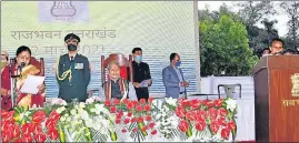  ?? HT PHOTO ?? Dhan Singh Rawat (right) takes oath as a minister in Dehradun on Friday.