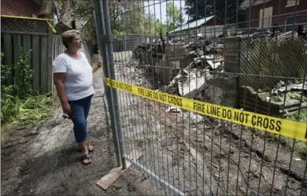  ?? MATHEW MCCARTHY, RECORD STAFF ?? Rhonda Piché stands next to the remains of a house on West Avenue that was destroyed by fire on Tuesday. Piché sent an email to the City of Kitchener in March complainin­g about the state of the vacant house.