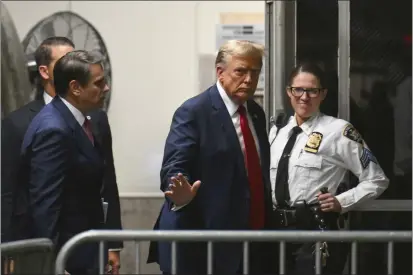  ?? ANGELA WEISS — POOL PHOTO ?? Former President Donald Trump gives a thumbs up as he returns to the courtroom after a break during the first day of his trial at Manhattan Criminal Court in New York, on Monday.