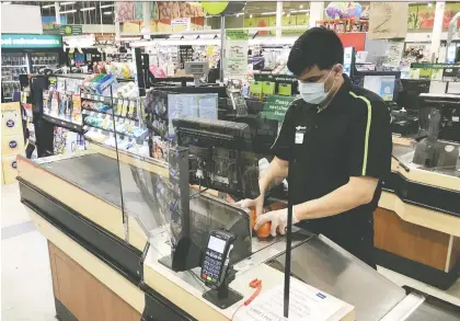  ?? JONATHAN HAYWARD/THE CANADIAN PRESS FILES ?? Four of Canada's biggest grocery chains have reported COVID infections swelling past 1,370 in January. The firms say the infection rate among their staff is lower than the national average. They added that most employees aren't getting infected at work.