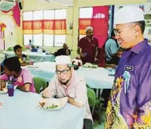  ??  ?? MOHD Razif (kanan) beramah mesra dengan pengunjung yang hadir pada Majlis Makan Sambil Menderma, semalam.