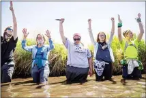  ?? (AP) ?? Everlastin­g Wind, aka Dawn Goodwin, joins others by raising her fist in the Mississipp­i River near an Enbridge pipeline constructi­on site, on Monday, June 7, 2021, in Clearwater County, Minn., to protest the constructi­on of Enbridge Line 3.