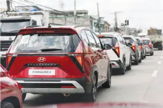  ?? ?? A convoy of Hyundai Stargazer X vehicles are queueing up to enter Clark in Pampanga.