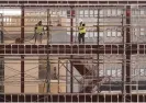  ?? Photograph: Damian Dovarganes/AP ?? Builders continue to work in downtown Los Angeles despite the heat. The National Weather Service warned the heat could continue through Friday.