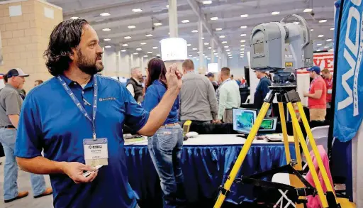  ?? [PHOTOS BY SARAH PHIPPS, THE OKLAHOMAN] ?? Billy Musick with AllTerra Central talks about his firm’s survey and mapping equipment at Thursday’s Oklahoma Oil &amp; Gas Expo in Oklahoma City.