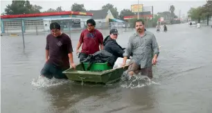  ?? AFP ?? People use a boat to evacuate their homes after the area was inundated with flooding in Houston. —