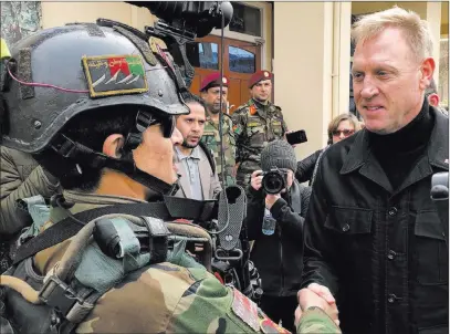  ?? Robert Burns The Associated Press ?? Acting Secretary of Defense Pat Shanahan greets an Afghan commando at Camp Commando, Afghanista­n, on Monday. The unannounce­d visit is Shanahan’s first to Afghanista­n.