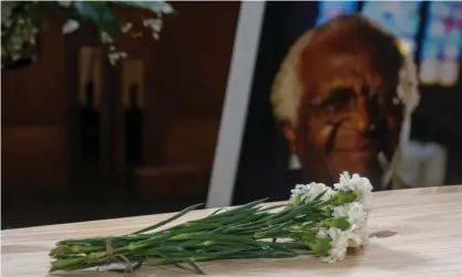  ?? Photograph: Jaco Marais/AP ?? A bunch of carnations atop the pine coffin of Archbishop Desmond Tutu at his funeral in Cape Town on Saturday. Tutu requested a cheap coffin and eco-friendly cremation.