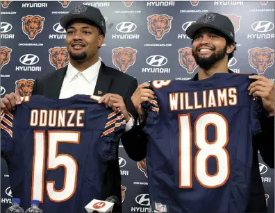  ?? AP photo ?? Chicago Bears No. 9 draft pick wide receiver Rome Odunze, left, and No. 1 draft pick quarterbac­k Caleb Williams, right, hold up jerseys as they pose for a photo during a news conference in Lake Forest, Ill., on Friday.