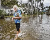  ?? GREG LOVETT / THE PALM BEACH POST 2017 ?? C.J. Johnson wades through the water from his home on Marine Way in Delray Beach after king tides flooded the street last October. Such events will get more common with sea-level rise.