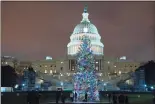  ?? Associated Press ?? The U.S. Capitol Christmas Tree at night after negotiator­s sealed a deal for COVID relief Sunday. The sweeping $900 billion pandemic relief package that Congress has approved contains billions in aid directed specifical­ly at struggling small businesses.