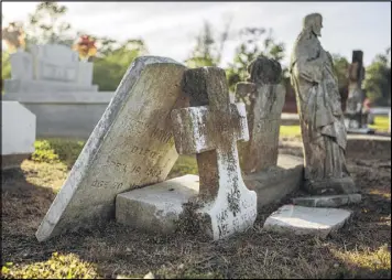  ?? WILLIAM WIDMER / THE NEW YORK TIMES ?? The headstone of Cornelius Hawkins’ grave leans against another at the Immaculate Heart of Mary Cemetery in Maringouin, La. Georgetown University sold Hawkins to a Louisiana plantation in 1838.