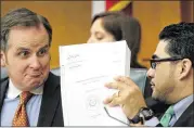  ?? RODOLFO GONZALEZ / AMERICAN-STATESMAN 2015 ?? State Reps. Bryan Hughes, R-Mineola (left), and Armando Walle, D-Houston, confer in March 2015. The budget process produces “a lot of posturing,” says a former state House leader.