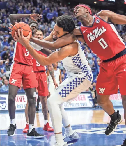  ?? MATT STONE/COURIER JOURNAL ?? Kentucky’s EJ Montgomery gets tangled with Ole Miss’ Blake Hinson while grabbing a loose ball in the Wildcats’ win over Ole Miss Saturday afternoon at Rupp Arena.