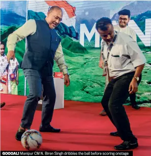  ??  ?? GOOOAL! Manipur CM N. Biren Singh dribbles the ball before scoring onstage