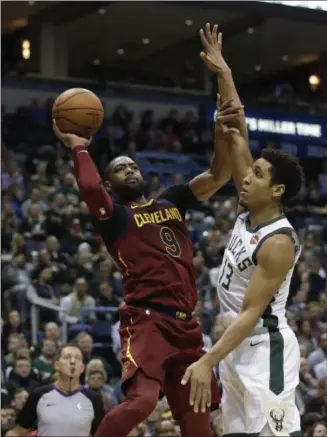  ?? MORRY GASH — THE ASSOCIATED PRESS ?? The Cavaliers’ Dwyane Wade shoots over the Bucks’ Malcolm Brogdon during the first half Dec. 19 in Milwaukee.