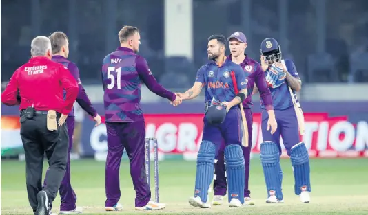  ?? PHOTOS AP ?? India’s captain Virat Kohli greets Scotland’s players after India won the Cricket Twenty20 World Cup match in Dubai, United Arab Emirates yesterday.
