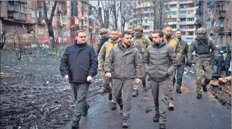  ?? AFP ?? Volodymyr Zelensky (centre) inspects damaged residentia­l buildings in Vyshgorod, outside of Kyiv, on Friday.