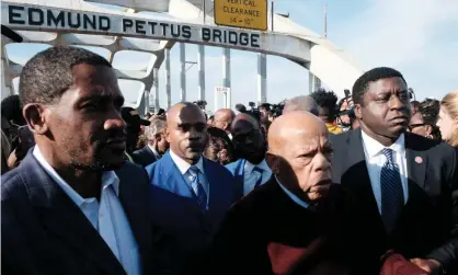  ??  ?? John Lewis crosses the Edmund Pettus Bridge in Selma in March, on the 55th anniversar­y of Bloody Sunday. Photograph: Michael McCoy/ Reuters