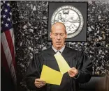  ??  ?? Judge Jeffrey Colbath, shown putting a jury sheet into evidence Thursday, told jurors to correct a “scrivener’s error” that resulted in marks on the verdict forms both for guilty and not guilty on the murder charge.