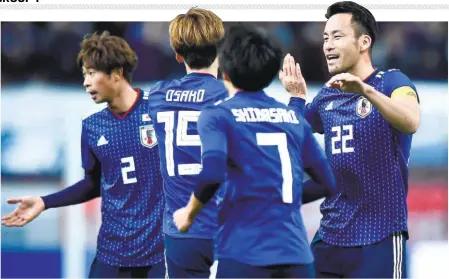  ??  ?? Top gun: Yuya Osako (No. 15) of Japan celebrates scoring a goal, with skipper Maya Yoshida (No. 22) during an internatio­nal friendly against Kyrgyzstan on November 20, 2018 in Toyota, Japan. With talismanic midfielder Keisuke Honda having retired from internatio­nal football after the World Cup and Shinji Kagawa’s omission from the squad, Yoshida is leading a rather young side at the Asian Cup. GETTY IMAGES