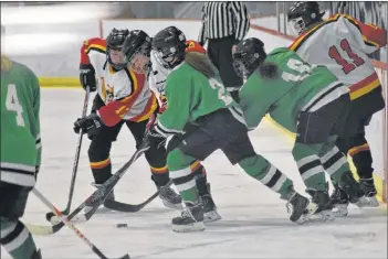  ?? ASHLEY THOMPSON PHOTO ?? Players from Central Kings and Horton scramble to gain possession of the puck in Peter Connell Memorial Girls Hockey Tournament action.