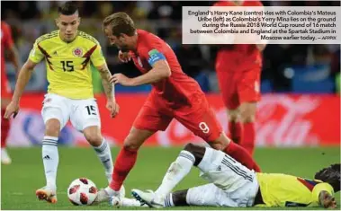  ??  ?? England’s Harry Kane (centre) vies with Colombia’s Mateus Uribe (left) as Colombia’s Yerry Mina lies on the ground during the Russia 2018 World Cup round of 16 match between Colombia and England at the Spartak Stadium in Moscow earlier today. –