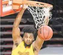  ?? KIM HAIRSTON/BALTIMORE SUN ?? Maryland’s Donta Scott watches the ball drop as he holds on to the rim in the first half against Wingate.