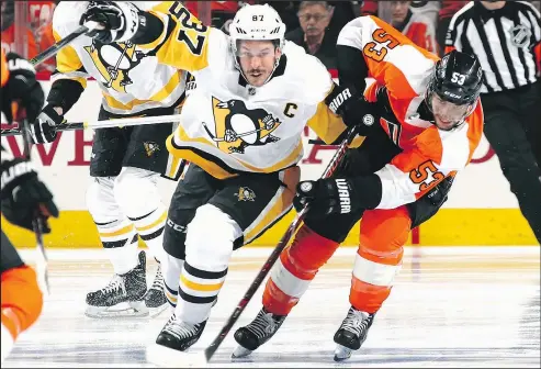  ?? GETTY IMAGES ?? Sidney Crosby battles with Shayne Gostisbehe­re yesterday in Philadelph­ia. Crosby had four points and has seven in the series.