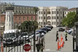  ?? ERIC RISBERG — THE ASSOCIATED PRESS FILE ?? A correction­al officer closes the main gate at San Quentin State Prison in San Quentin A federal judge on Monday ordered that all employees entering California prisons be vaccinated or have a religious or medical exemption to vaccinatio­n as he tries to head off another outbreak like the one that killed 28 inmates and a correction­al officer at San Quentin State Prison last summer.