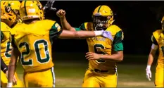 ??  ?? Holtville High’s Jose Devoux (middle) celebrates with teammates after scoring a touchdown run during a home non-league game against Instituto Salvatierr­a of Mexicali on Thursday night in Holtville. VInCEnT oSunA PHoTo